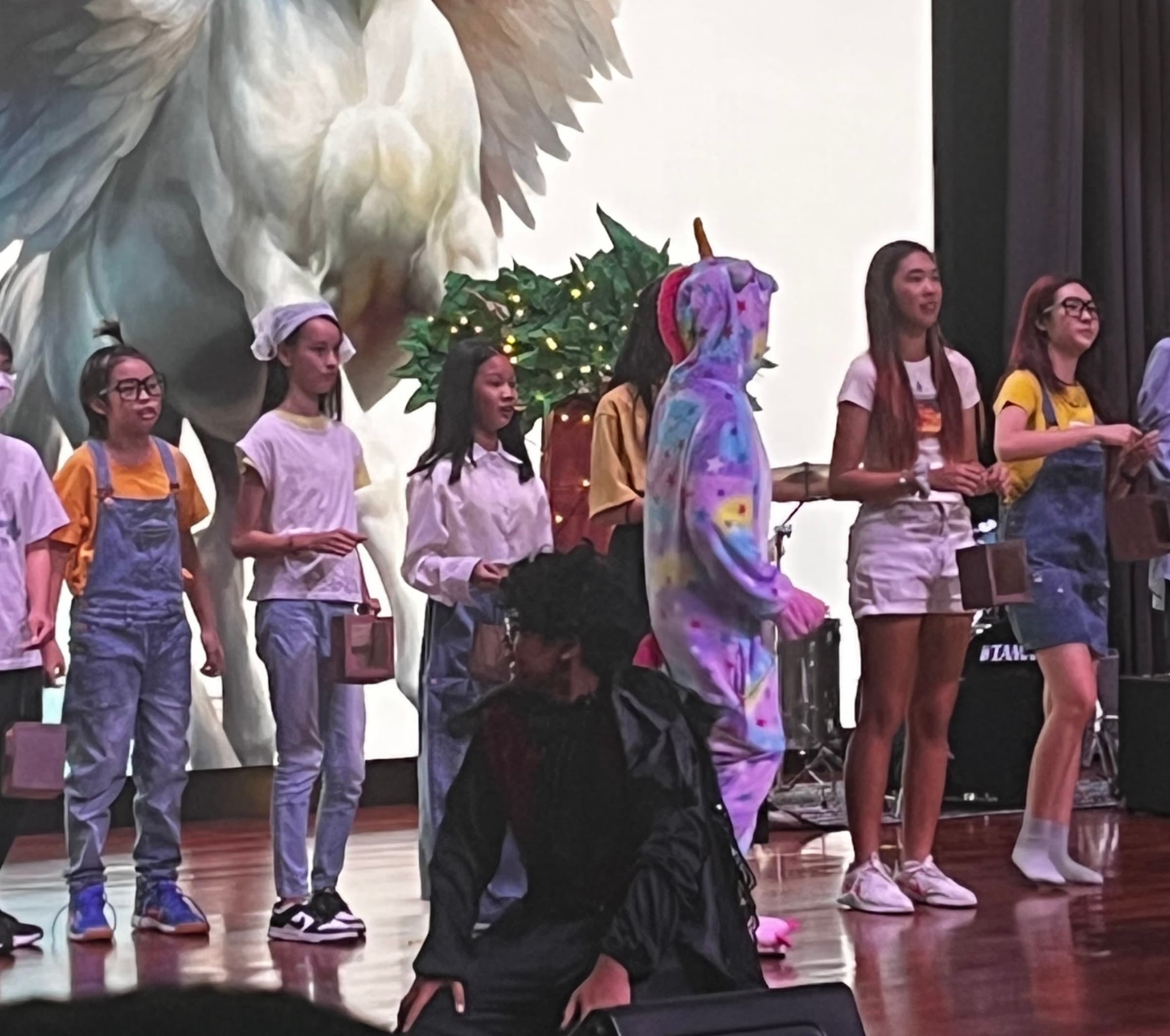 Students in costume on stage during Theme Week 2024